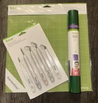 New Cricut Bundle: 12X12 Standard Grip Mat, Weeding Tool Set, + Roll Of Iron-on. Fixed Price $7.95.
